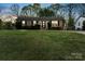 Charming brick home at dusk featuring a well-manicured lawn and inviting front entrance at 4932 Delivau Dr, Charlotte, NC 28215