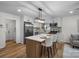 Modern kitchen with stainless steel appliances, white cabinetry and island seating at 4932 Delivau Dr, Charlotte, NC 28215