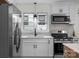 Updated kitchen features stainless steel appliances and sleek white cabinetry at 4932 Delivau Dr, Charlotte, NC 28215