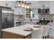 Modern kitchen with stainless steel appliances, white cabinetry and tiled backsplash at 4932 Delivau Dr, Charlotte, NC 28215
