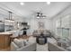 Modern open-concept layout with kitchen, living and dining areas under ceiling fan at 4932 Delivau Dr, Charlotte, NC 28215