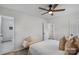 Relaxing primary bedroom featuring a bench, soft colors and ceiling fan at 4932 Delivau Dr, Charlotte, NC 28215