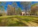Expansive green backyard featuring mature trees and a detached garage at 605 Ottawa Dr, Rock Hill, SC 29732