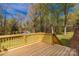 A wooden deck overlooking the large backyard, surrounded by mature trees at 605 Ottawa Dr, Rock Hill, SC 29732