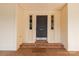 A close-up view of the home's front door, flanked by sidelights and brick porch at 605 Ottawa Dr, Rock Hill, SC 29732