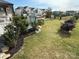 This beautiful backyard features an outdoor kitchen, a patio, lush landscaping, and a black metal fence at 6499 Gopher Rd, Lancaster, SC 29720