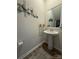 Powder room featuring a pedestal sink, modern decorations, and wood-look flooring at 6499 Gopher Rd, Lancaster, SC 29720