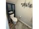 Powder room featuring a toilet, vanity, and modern decorations at 6499 Gopher Rd, Lancaster, SC 29720