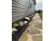 A side yard with stone and mulch landscaping, rock features, and a paved walkway at 6499 Gopher Rd, Lancaster, SC 29720