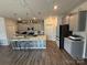 Well-appointed kitchen with an island, modern appliances, gray cabinets and wood flooring at 6499 Gopher Rd, Lancaster, SC 29720