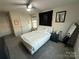 Bright main bedroom with a ceiling fan, neutral walls, and plush white bedding at 6499 Gopher Rd, Lancaster, SC 29720