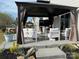Outdoor patio featuring a gazebo, comfortable white seating, and manicured landscaping at 6499 Gopher Rd, Lancaster, SC 29720