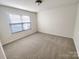 Neutral bedroom featuring carpet, a window, and light walls at 6525 Soapstone Dr, Charlotte, NC 28269