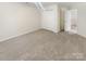 A carpeted bedroom with double closets and natural light from a window, offering a peaceful retreat at 6525 Soapstone Dr, Charlotte, NC 28269