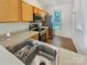 Well-lit kitchen featuring stainless steel appliances, light cabinets, and solid surface countertops at 6525 Soapstone Dr, Charlotte, NC 28269