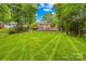 Expansive backyard featuring meticulously manicured lawn that create a serene retreat perfect for relaxing and entertaining at 6744 Wheeler Dr, Charlotte, NC 28211