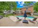 Relaxing backyard oasis featuring a refreshing pool, sun-loungers, a bar area, and a spacious wooden deck for outdoor entertaining at 6744 Wheeler Dr, Charlotte, NC 28211