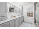 Modern bathroom featuring double vanity and large mirror at 6744 Wheeler Dr, Charlotte, NC 28211