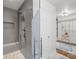 Bathroom featuring a shower and a glimpse into the laundry room at 6744 Wheeler Dr, Charlotte, NC 28211