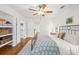 Bedroom with an metal frame bed, light hardwood floors, walk in closet and a view into the hallway at 6744 Wheeler Dr, Charlotte, NC 28211