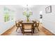 Stylish dining room with a wood table, modern chandelier, and bright natural light through a large window at 6744 Wheeler Dr, Charlotte, NC 28211
