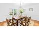 Elegant dining room with a wooden table, modern chandelier, and large window, ideal for gatherings at 6744 Wheeler Dr, Charlotte, NC 28211