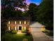 Charming brick two-story home with manicured lawn and welcoming entrance, complemented by lush landscaping at 6744 Wheeler Dr, Charlotte, NC 28211