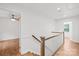 Upstairs hallway with wood floors and access to multiple rooms at 6744 Wheeler Dr, Charlotte, NC 28211