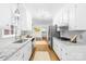 Bright kitchen with white cabinets, granite countertops, stainless steel appliances, and modern fixtures at 6744 Wheeler Dr, Charlotte, NC 28211