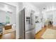 Open concept kitchen with stainless steel refrigerator and view into adjacent living spaces at 6744 Wheeler Dr, Charlotte, NC 28211