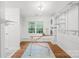A clean laundry room with a window, washer, dryer and wire rack shelves at 6744 Wheeler Dr, Charlotte, NC 28211