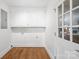Bright laundry room featuring built-in cabinets and a glass paneled door at 6744 Wheeler Dr, Charlotte, NC 28211