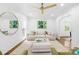 Spacious living room with hardwood floors, white sofa, and decorative accents with lots of natural light at 6744 Wheeler Dr, Charlotte, NC 28211