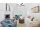 Bright living room featuring a fireplace, comfortable seating, and natural light streaming through the window at 6744 Wheeler Dr, Charlotte, NC 28211