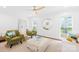 Bright living room featuring hardwood floors, a modern ceiling fan, and comfortable seating arrangement at 6744 Wheeler Dr, Charlotte, NC 28211