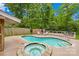 Backyard pool and hot tub with tanning deck. A perfect space for outdoor recreation and relaxation with a deck area at 6744 Wheeler Dr, Charlotte, NC 28211