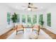 Sunroom features lots of windows, ceiling fan, and comfortable seating at 6744 Wheeler Dr, Charlotte, NC 28211