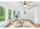 Bright sitting area with ceiling fan, lots of windows, and view of the trees at 6744 Wheeler Dr, Charlotte, NC 28211