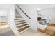 Beautiful staircase with wood and white accents leads to the second floor at 6744 Wheeler Dr, Charlotte, NC 28211