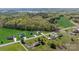 An aerial view shows the property's location near a lake and surrounded by lush greenery at 7205 Church Rd, Taylorsville, NC 28681