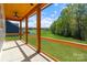 Inviting back porch with wood ceiling overlooks spacious backyard at 7205 Church Rd, Taylorsville, NC 28681