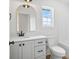 Modern bathroom with white vanity, gold mirror, and natural light from window at 7205 Church Rd, Taylorsville, NC 28681