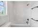 Modern bathroom features white tub and dark hardware at 7205 Church Rd, Taylorsville, NC 28681