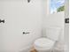Elegant half-bathroom with a clean design and a window for natural light at 7205 Church Rd, Taylorsville, NC 28681