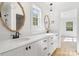 Bathroom with double sinks, granite countertops, framed mirrors, and wood look floors at 7205 Church Rd, Taylorsville, NC 28681