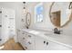 Bright bathroom with double sinks, white cabinets and wood look floors at 7205 Church Rd, Taylorsville, NC 28681