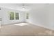 Spacious bedroom with carpet, white walls, two windows and a ceiling fan at 7205 Church Rd, Taylorsville, NC 28681
