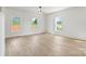 Bright bedroom with three windows, wood-look floors and a ceiling fan at 7205 Church Rd, Taylorsville, NC 28681