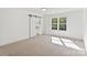 Bright bedroom with carpet, white walls, a barn door, and a window at 7205 Church Rd, Taylorsville, NC 28681