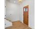 Entryway with a wooden front door, carpeted stairs and light wood floors at 7205 Church Rd, Taylorsville, NC 28681